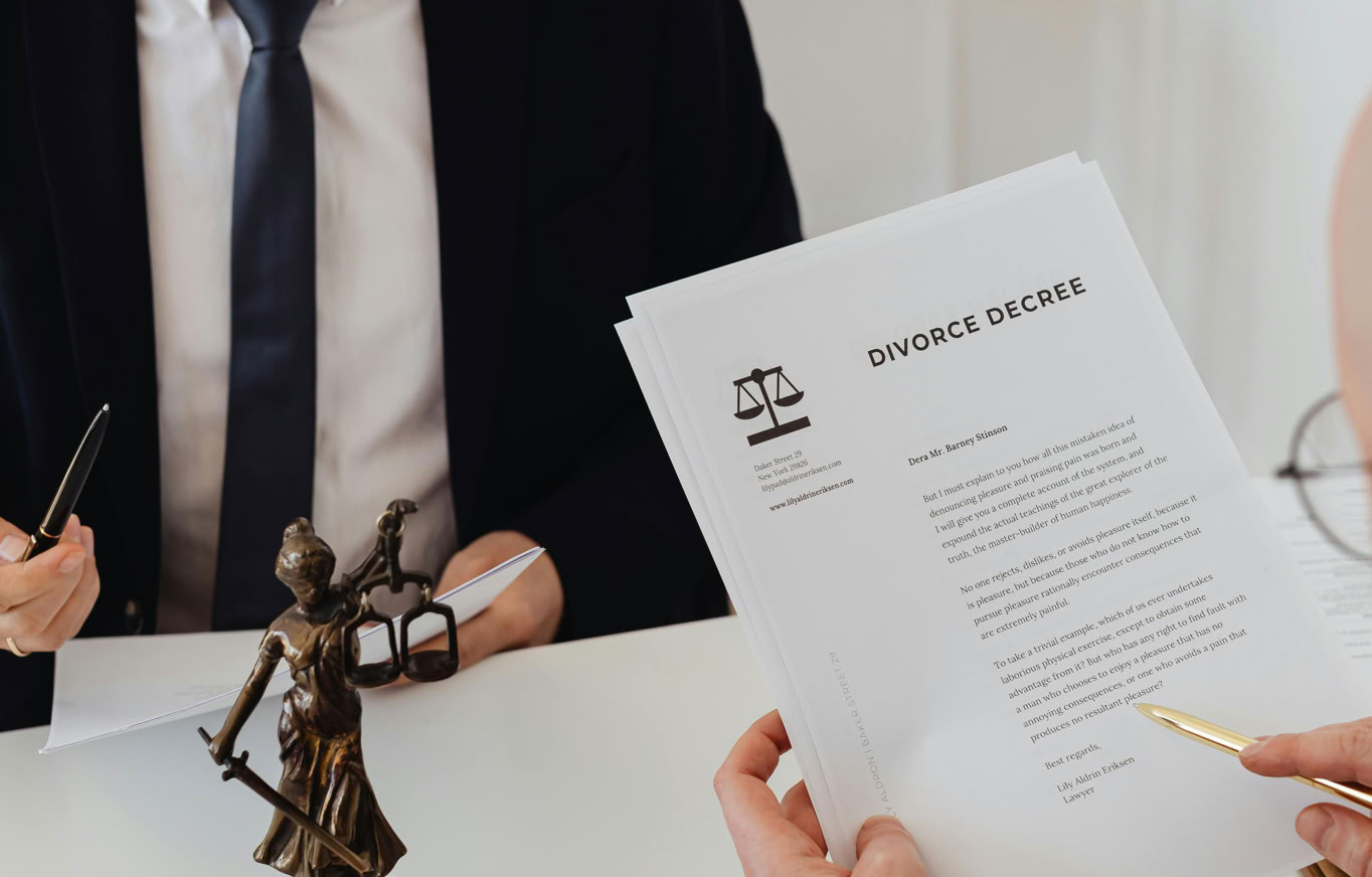 Two lawyers discussing divorce decree documents in a professional office setting.